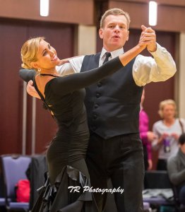 A photo of John and Jessica owner of Windy City Wedding Dance competing in ballroom dancing in Chicago